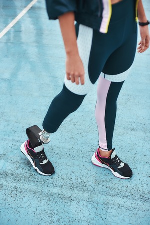 Just keep running. Cropped image of disabled woman in sportswear with bionic leg standing on stadium...