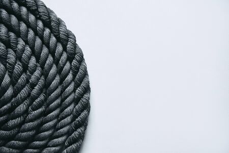 Close up of black battle rope on a gray backgound. Sport and fitness equipmentの写真素材
