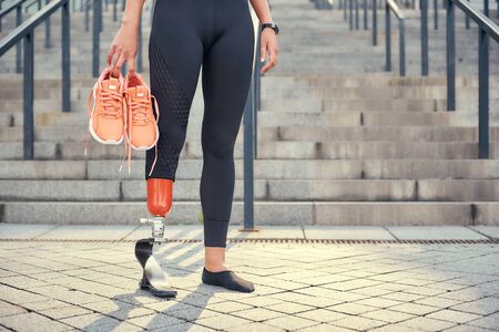 Keeping my body healthy. Cropped photo of woman with leg prosthesis in sports clothing carrying her...