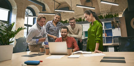 Business professionals at work. Multicultural team, group of young cheerful business people...