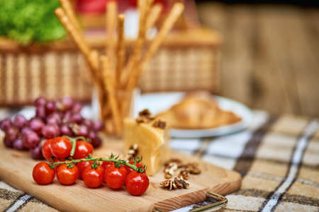 Delicious food on a plaid blanket for picnic