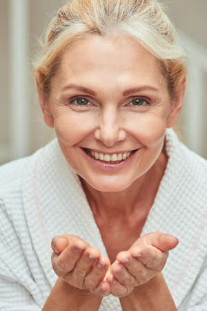 Middle aged caucasian woman with open palmsの写真素材