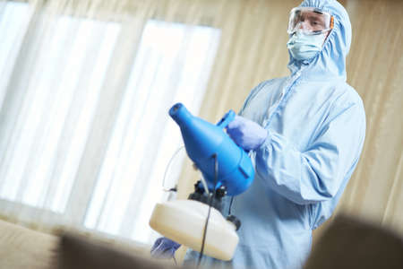Worker in mask making disinfection to prevent the spread of covid19