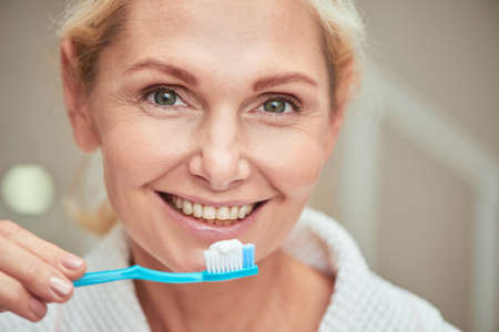 Portrait of middle aged caucasian woman with toothbrushの写真素材