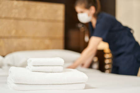 Housemaid preparing the room for the arrival of guests