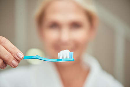 Toothbrush with white paste in handの写真素材