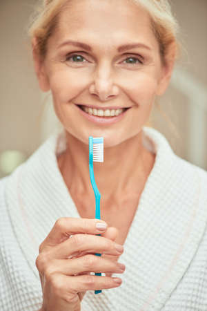 Beautiful middle aged caucasian woman with toothbrushの写真素材