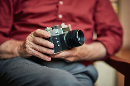 Cropped photo of male hands with rare cameraの写真素材