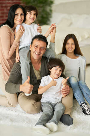 My family is my treasure. Portrait of latin family, teenage daughter and little boys smiling at...