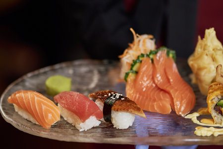 Set of various kinds of sushi layed out on plate