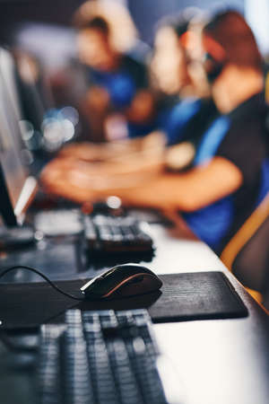 Close up vertical shot of professional cyber sportsman workplace with desktop computer, keyboard and mouse, selective focusの写真素材