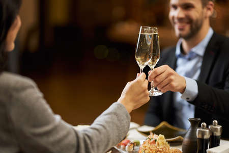 Cheerful man drinking champagne with his wifeの写真素材