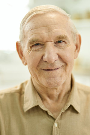 Joyful grandpa posing for the camera and looking optimistic