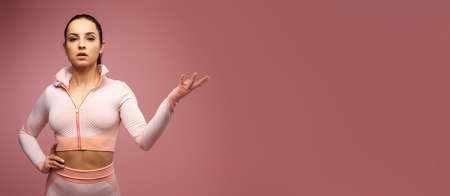 Website header of Beautiful young woman in sportswear posing in studioの写真素材