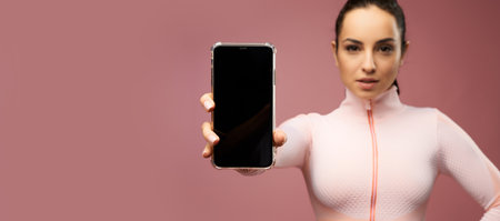 Website header of Attractive young woman holding smartphone with black displayの写真素材