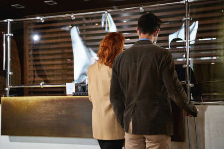 Man and woman coming to the reception deskの写真素材