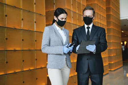Hotel manager and receptionist looking at the tablet screenの写真素材