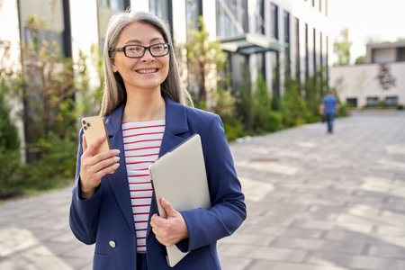 Joyous businesswoman taking a walk to her workplaceの写真素材