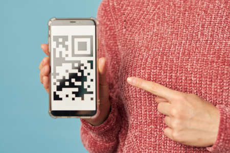 Female shopper with modern gadget in her hands while shopping onlineの写真素材