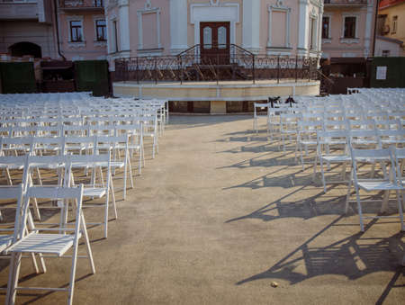 White chairs for viewers at outdoors concert hall