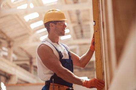 Joyful male builder working at construction site