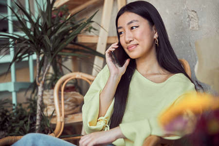 Smiling attractive woman sitting in coffee shop