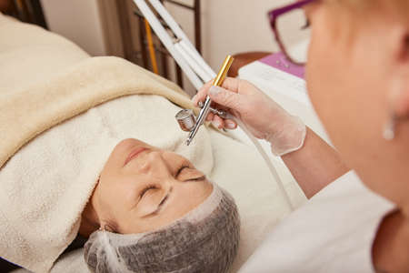 Charming woman having oxygen mesotherapy procedure in clinicの写真素材