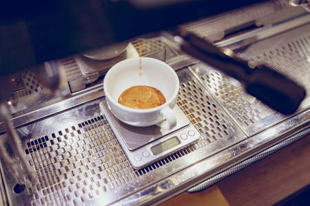 Professional coffee machine brewing espresso in cafeの写真素材