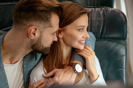 Couple in love hugging in passenger airplaneの写真素材