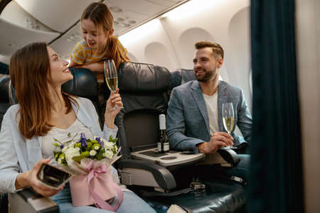 Joyful woman traveling with family on airplane