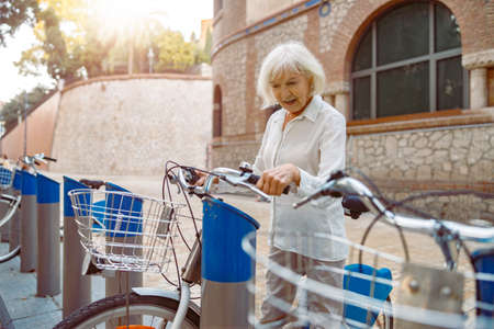 Senior lady spending time at urban areaの写真素材