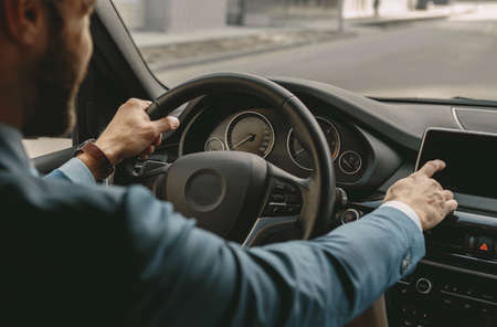 Unrecognized male driving a car in the city street
