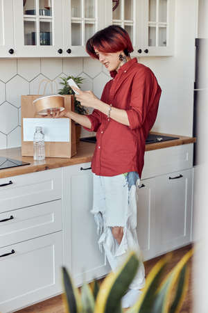 Happy guy making video on the phone about the delivery of food online