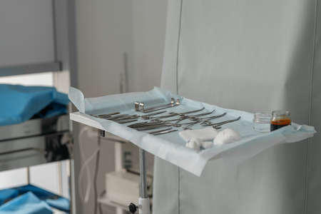Surgical instruments and tools including scalpels forceps and tweezers arranged on table for surgeryの写真素材