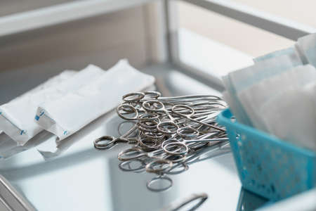 Surgical instruments such as forceps arranged on table for surgery