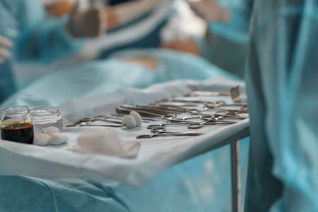 Surgical instruments and tools including scalpels forceps and tweezers arranged on table for surgeryの写真素材