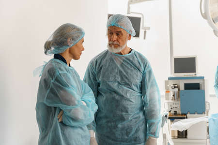 Two doctors surgeons are conferring in the operating room before the surgery