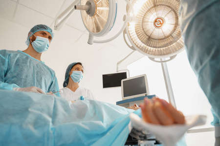 Focused surgical team working with a patient in an operation room