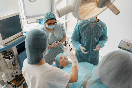 Well-trained anesthesiologist follows the patient during the surgery in clinic