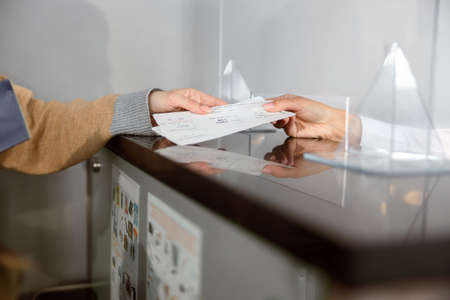 Close up of airport check-in counters with passengersの写真素材