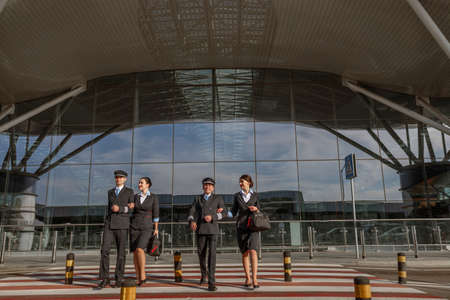 Flight team crossing the road outdoor with terminal on the backgroundの写真素材