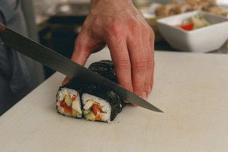 Close up of man japanese restaurant chef cooking sushi in the kitchenの写真素材