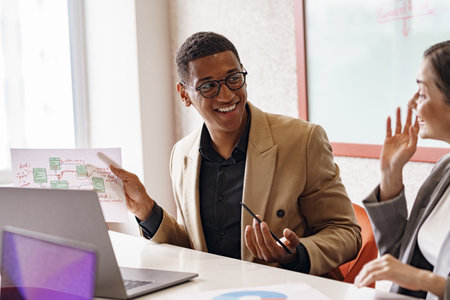 Smiling coworkers cooperating and working together at coworking space, teamwork conceptの写真素材