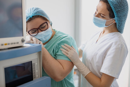 Tired nurses after difficult operation support each other in operating roomの写真素材