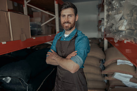 Portrait of warehouse worker in uniform of small coffee factoryの写真素材