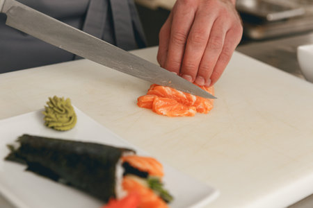 Close up of man japanese restaurant chef cooking sushi in the kitchenの写真素材