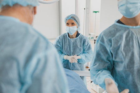 Professional surgical team working with a patient in an operation room of modern clinicの写真素材
