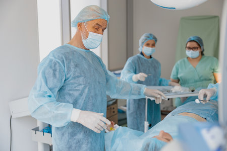 Professional surgical team working with a patient in an operation room of modern clinic