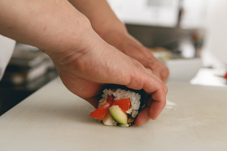 Close up of man japanese restaurant chef cooking sushi in the kitchenの写真素材