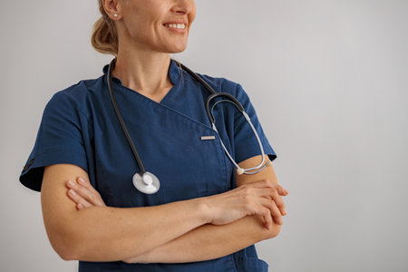 Close up of woman doctor with stethoscope in hospital looking sideの写真素材